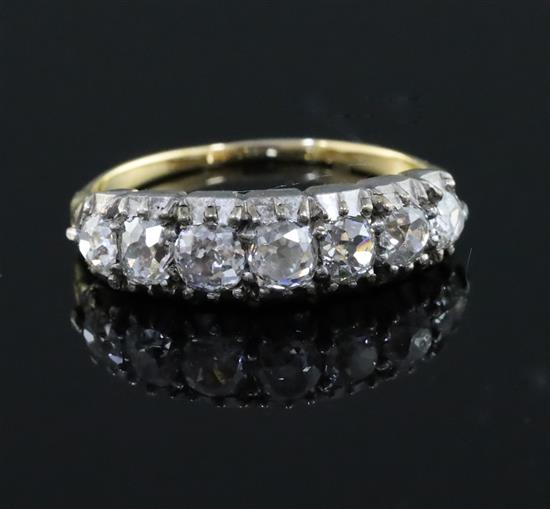 An early 20th century gold and graduated old cut diamond seven stone diamond half hoop ring, size M.